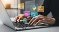 Developer typing code on laptop with programming languages icons overlay Royalty Free Stock Photo