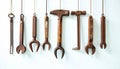 Collection of Antique Rustic Brown Metal Tools Hanging on White Wall AI generated. Royalty Free Stock Photo