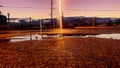 Sunset Puddle Reflections In a Silent Parking Lot Royalty Free Stock Photo