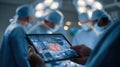 Captivating medium shot of a tablet showing live autobalancing of operatingroom cases using AI with a softly blurred Royalty Free Stock Photo