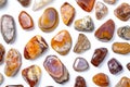 Exploring the vivid beauty of fire agate and various mineral samples displayed on a clean white background Royalty Free Stock Photo