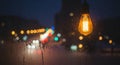 Atmospheric Night Scene - Illuminated Bulb and Blurred City Lights Royalty Free Stock Photo
