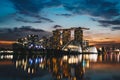 Nighttime view of the Marina Bay skyline in Singapore, with its reflections in the tranquil water