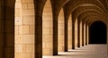 Ancient Stone Arches Corridor with Sunlight and Shadows Royalty Free Stock Photo