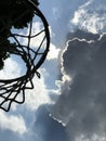 Skyward Hoop Dreams: Nature's Silhouette Against the Clouds - Basketball Royalty Free Stock Photo