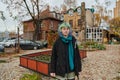 A captivating portrait of a young, interesting girl with striking blue hair, taken in the park in front of her house