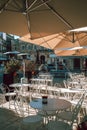 Ostuni\'s Historic Center Beautiful Piazza with Parasols Against Clear Blue Sky