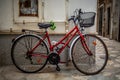 Vintage Charm: Red Bicycle Against Wall in a Typical Street of Polignano a Mare, Italy