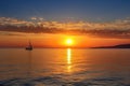 captivating sunrise over the sea, with sailboat and yacht in view