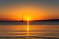 captivating sunrise over the sea, with sailboat and yacht in view