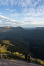 Captivating Sunset View: Tourists Overlook Canyon and Valley. At a lookout at the three sisters in the blue mountains