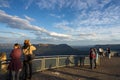 Captivating Sunset View: Tourists Overlook Canyon and Valley. At a lookout at the three sisters in the blue mountains