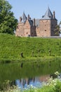 Captivating view across the moat water over the dike to Slot Loevestein Castle and its rich history. The fortress is the most