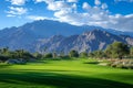 A captivating view of a golf course surrounded by towering mountains, creating a stunning landscape for golfers to enjoy their Royalty Free Stock Photo