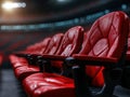 Capture the energy of expansive stadium seating during an event, with rows of vibrant red chairs under dynamic stadium lighting, Royalty Free Stock Photo