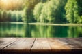 Smooth wooden tabletop in the lush verdant forest with sparkling summer lake for product display