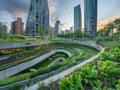 Capture the essence of urban greening innovation from a dynamic tilted angle Show a vibrant cityscape transformed by sustainable