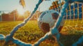 Capture the exact moment a soccer ball curves into the net, with the goalie's outstretched hands blurred in the Royalty Free Stock Photo