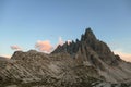 A capture of high and sharp peaks of Dolomites in Italy during the golden hour. The sky is full of soft clouds.