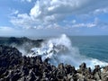 Capture of the light sea blue waves of the Indian Ocean crashing against the jagged limestone edges,