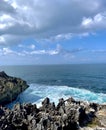 Capture of the light sea blue waves of the Indian Ocean crashing against the jagged limestone edges.