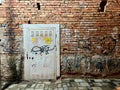 Urban Electric Conduit: Graffiti-Adorned Brick Wall