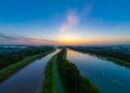 Dawn's Reflection: Sunlit Waterways Under Steel Sky Royalty Free Stock Photo