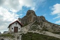 A capture of a small chapel, with red rooftop and small bell tower in Italian Dolomites. There are high Alpine peaks around. Royalty Free Stock Photo