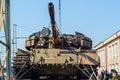 Captured tank of terrorists with artisanal reactive armor on a railway flatcar