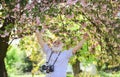 Capturing beauty life journey. Photographer in blooming garden. Sakura petals falling down. Vintage camera. Retro camera