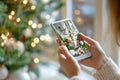 Capturing festive holiday decorations on a smartphone by the christmas tree Royalty Free Stock Photo
