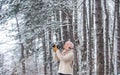 Capturing winter. Taking stunning winter photos. Winter hobby. Enjoy beauty of snow scenery through photos. Woman