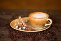 Capuccino with beautiful decorations along with coffee beans Royalty Free Stock Photo