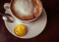 Capuccino and bitcoin gold coin on the table in cafe top view Royalty Free Stock Photo