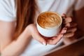 Capuccino in hands of young girl Royalty Free Stock Photo