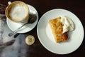 Capuccino, pancake with sour cream and bitcoin gold coin on the table in cafe Royalty Free Stock Photo