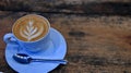 Capucino coffee in a cup on a wooden table Royalty Free Stock Photo
