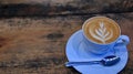 Capucino coffee in a cup on a wooden table Royalty Free Stock Photo