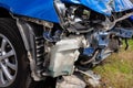 Car after an accident - broken headlights, hood and bumper