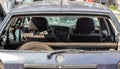 A car after an accident with a broken rear window. Broken window in a vehicle. The wreckage of the interior of a modern car after