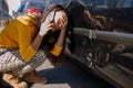 Car accident concept. woman in a state of shock talking on the phone after a car accident