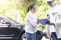Car accident Car crash The woman talking to Insurance agent about the accident. Insurance agent writing document on clipboard of Royalty Free Stock Photo