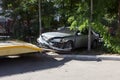 Car accident, head-on collision. Tow truck loads a wrecked car after an accident