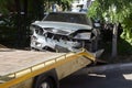 Car accident, head-on collision. Tow truck loads a wrecked car after an accident