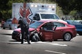 Car Accident Red Car with Ambulance in Background Smashed Front Bumper