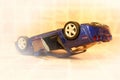 Car accident, toy car, turned upside down by wheels, road crash concept, vignette Royalty Free Stock Photo