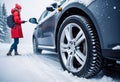 Car accident in winter, Woman waiting for help on the road after an accident on a snowy slippery road, following traffic rules, Royalty Free Stock Photo