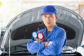 Car Air Conditioning Repair, Repairman holding monitor tool to check and fixed car air conditioner system, Technician check car