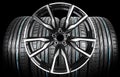Car alloy wheel and tyre isolated on black background. New alloy wheel with tire for a car on a black background. Alloy rim isolat Royalty Free Stock Photo