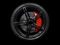 Car alloy wheel and tyre isolated on black background. New alloy wheel with tire and red carbon ceramic brakes. Alloy rim isolated